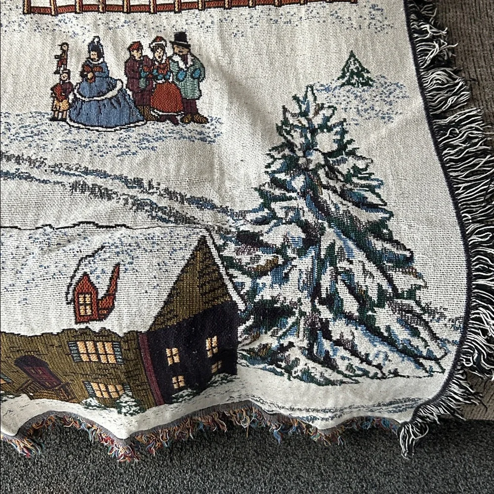 woven tapestry throw blanket featuring a winter village scene fringe edges